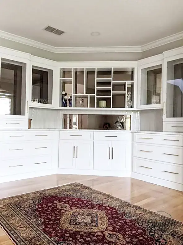 White cabinetry with glass-front upper doors